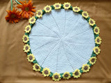 Round crochet mat with sunflower design on a brown background