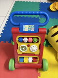 Colorful toy push cart with multiple interactive elements
