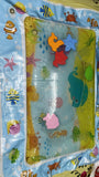 Children's play mat with ocean-themed illustrations and colorful characters.