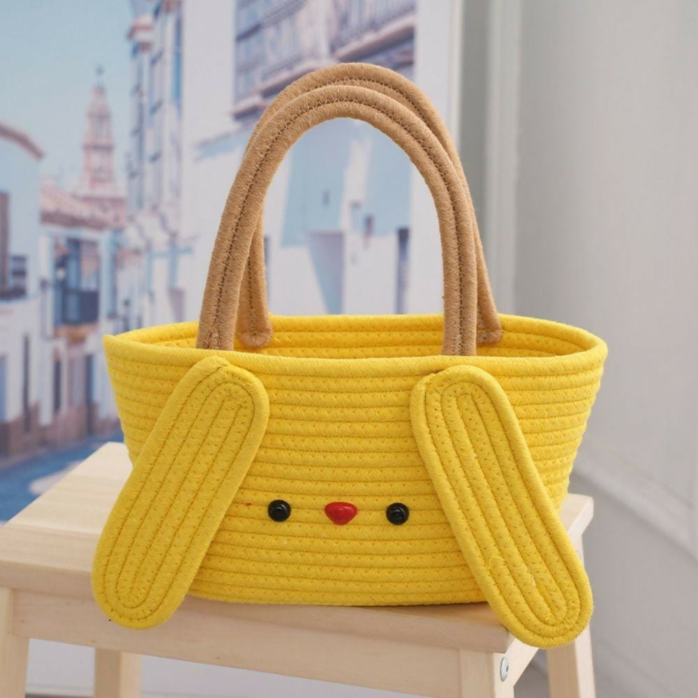 Yellow basket with bunny ears and a face on a chair