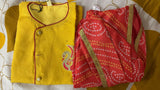 Yellow and red traditional outfit with a patterned fabric on a yellow background