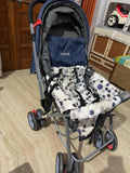 Stroller with a patterned cover on a wooden floor