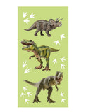 Three toy dinosaurs on a green background