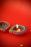 Embrace the spirit of creativity and tradition with our DIY Diya Kit, a delightful set designed to ignite your artistic flair while celebrating the warmth of Diwali. This kit includes five beautiful diyas and a palette of vibrant paint colors, allowing you to personalize and illuminate your festival of lights.