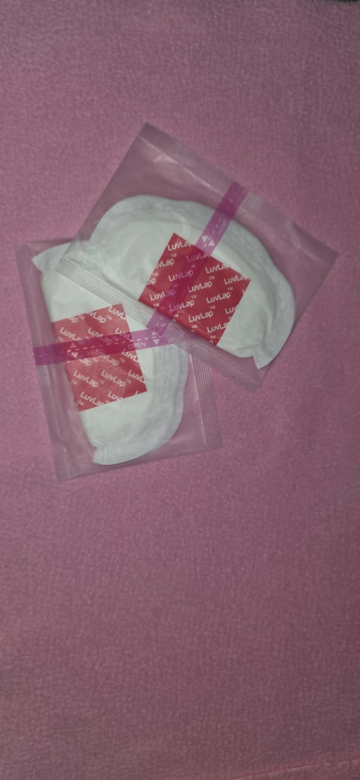 White product in a clear plastic bag with red label on a pink background