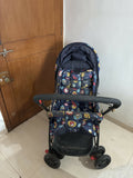 Babyhug Cosy Cosmo Stroller with a lightweight foldable frame, reclining seat, adjustable canopy, 5-point safety harness, smooth wheels, and spacious storage basket for safe and comfortable travel with babies and toddlers.