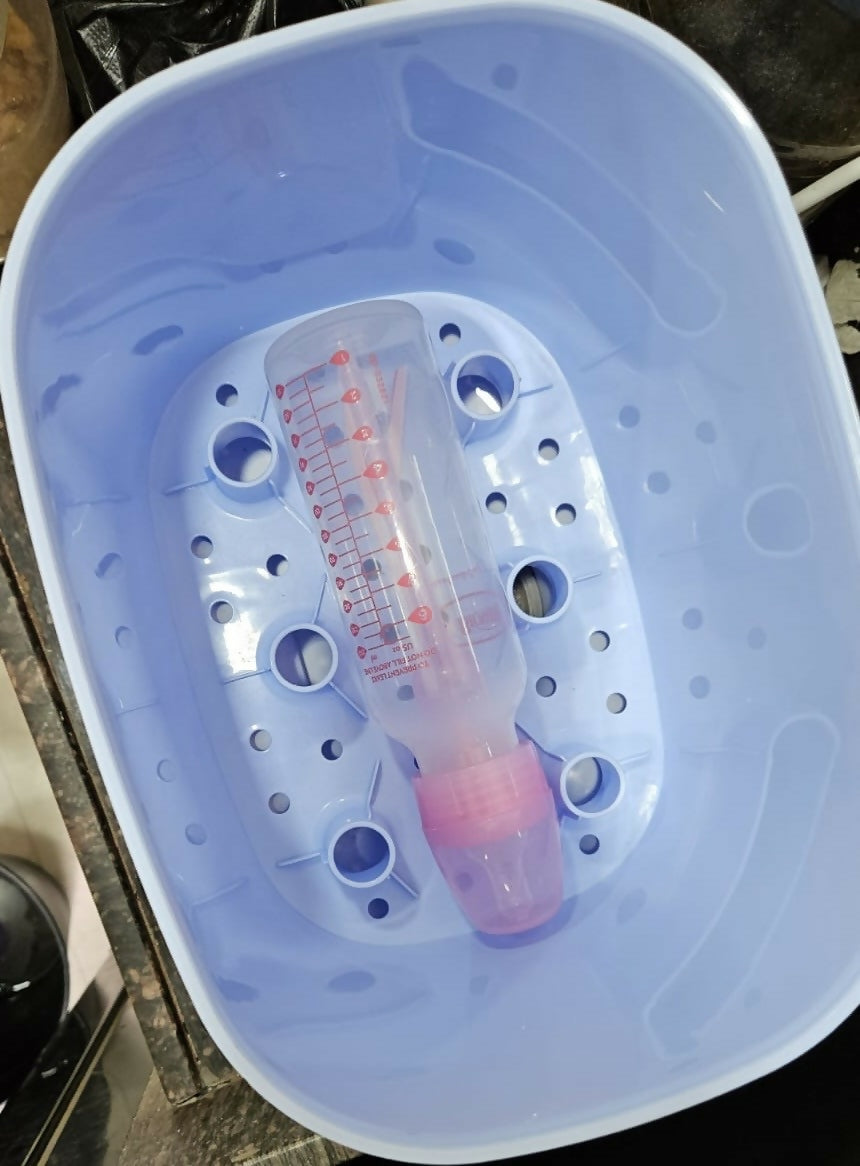 BPA-free baby bottle sterilizer with a pink and clear bottle inside on a white background