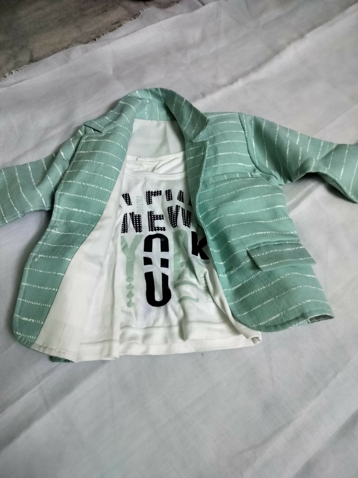 Upgrade your child's wardrobe with our Overcoat paired with a Sleeveless T-Shirt, offering style and comfort for everyday wear.