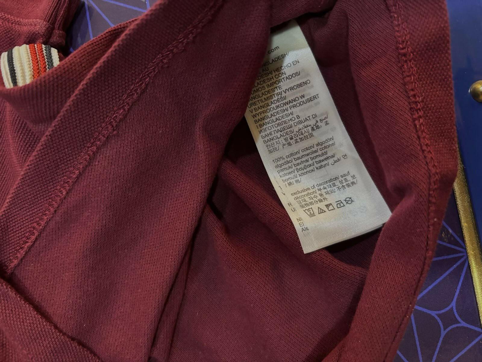 TOMMY HILFIGER maroon polo neck T-shirt featuring soft comfortable fabric, classic polo collar, short sleeves, and a smart casual look for everyday wear and outings.