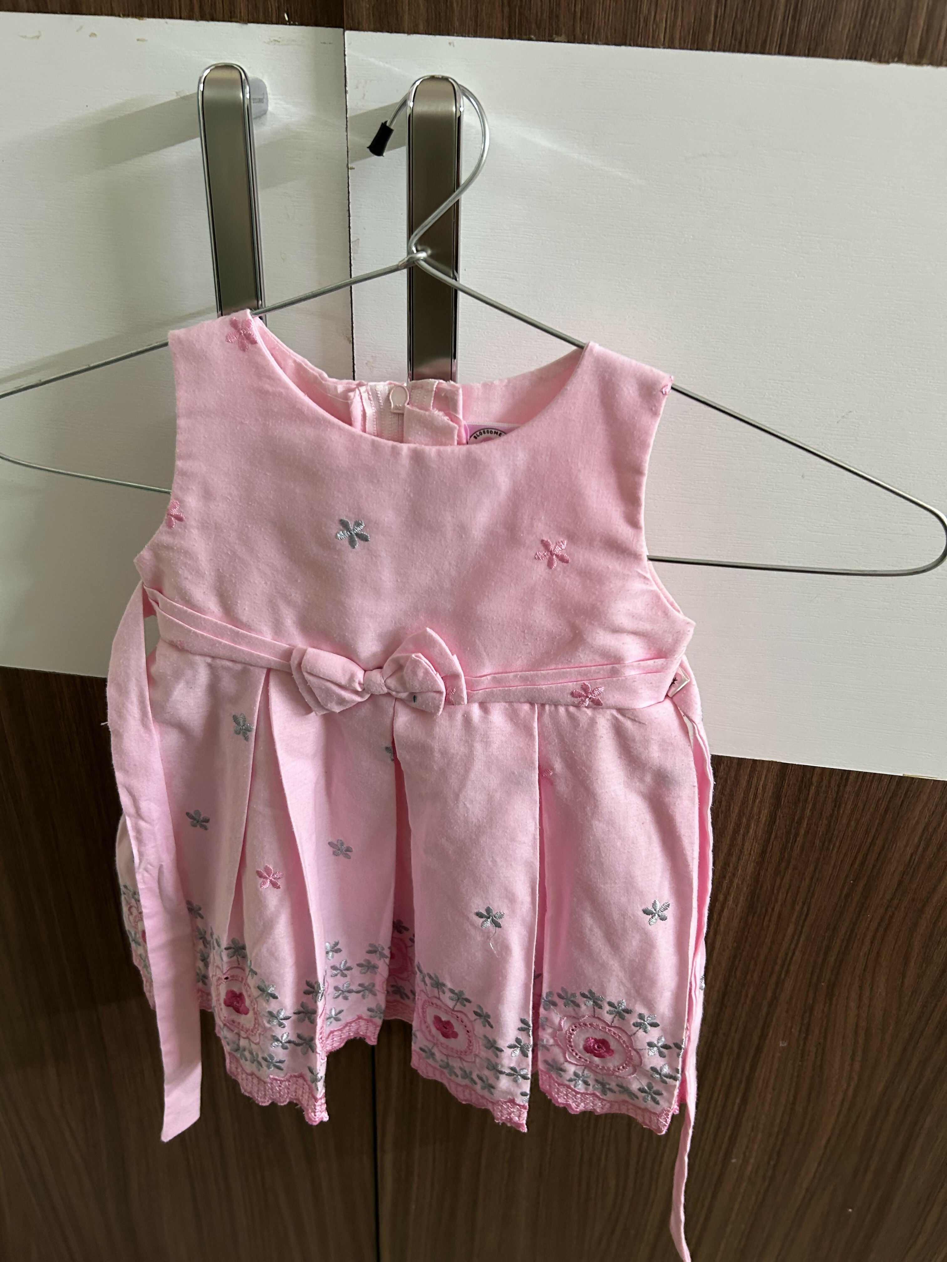 Pink children's dress with floral patterns