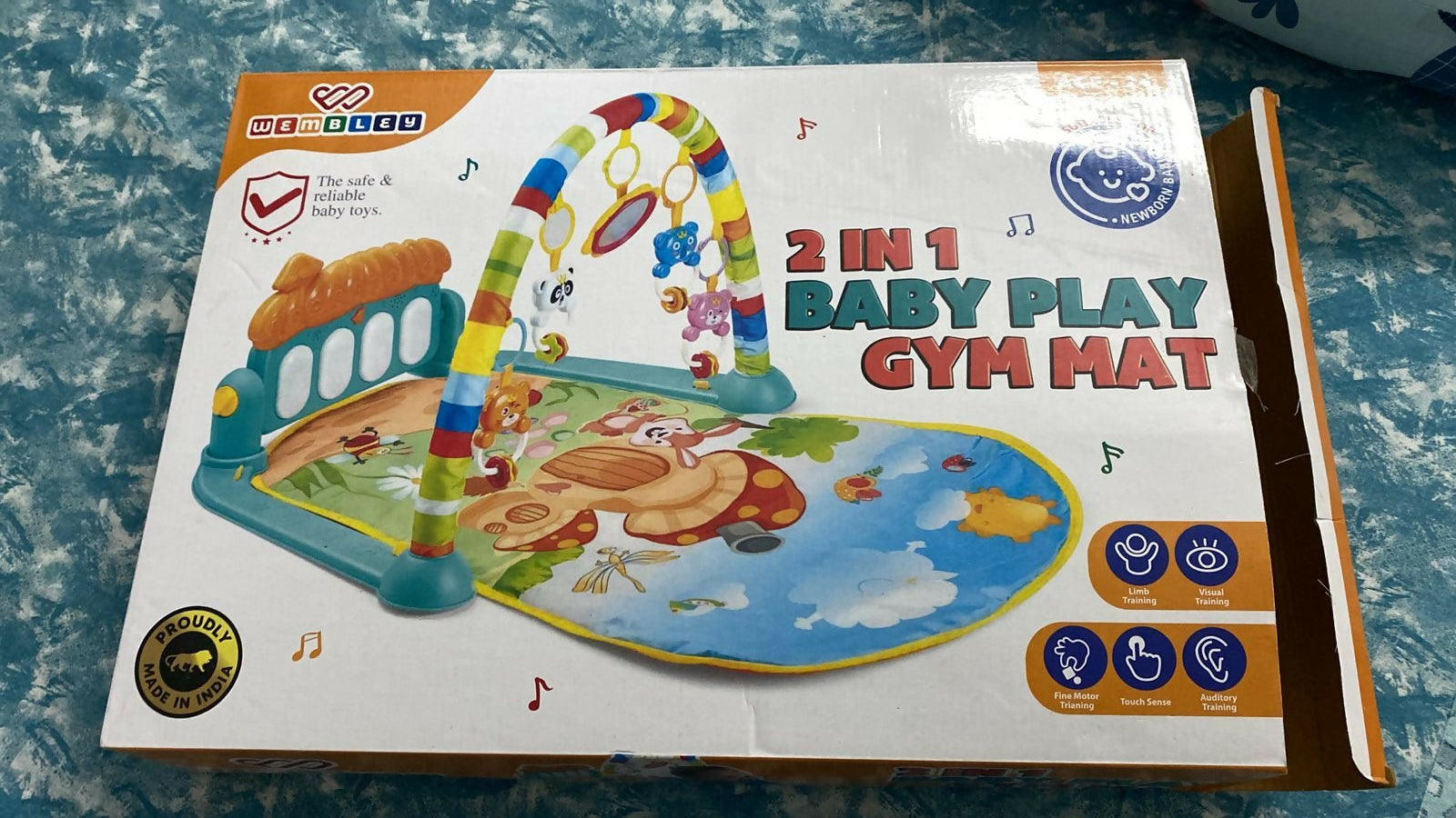 Baby play gym mat packaging on a textured surface