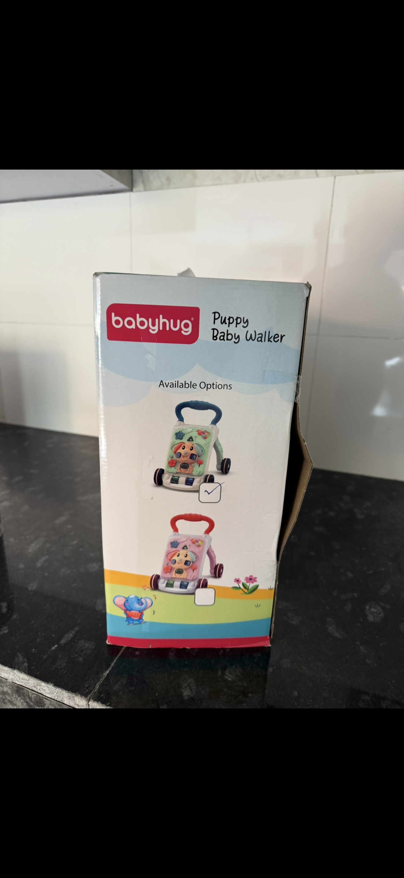 Babyhug puppy baby walker packaging on a black surface with a white background