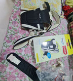 Luvlap baby carrier on a floral bedspread with packaging