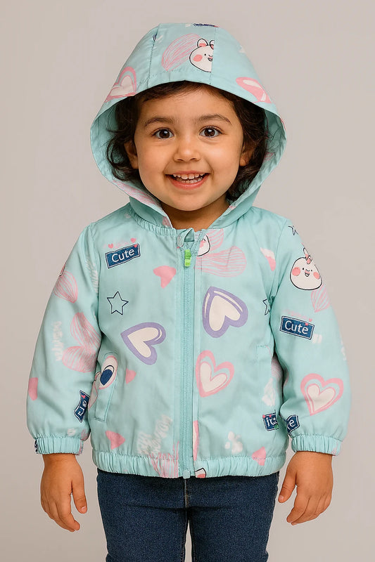 Child wearing a light blue jacket with heart patterns and a matching hat