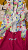 Colorful geometric-patterned jacket over a pink garment with 'My craft' text on a patterned background