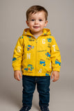 Child wearing a yellow jacket with colorful designs