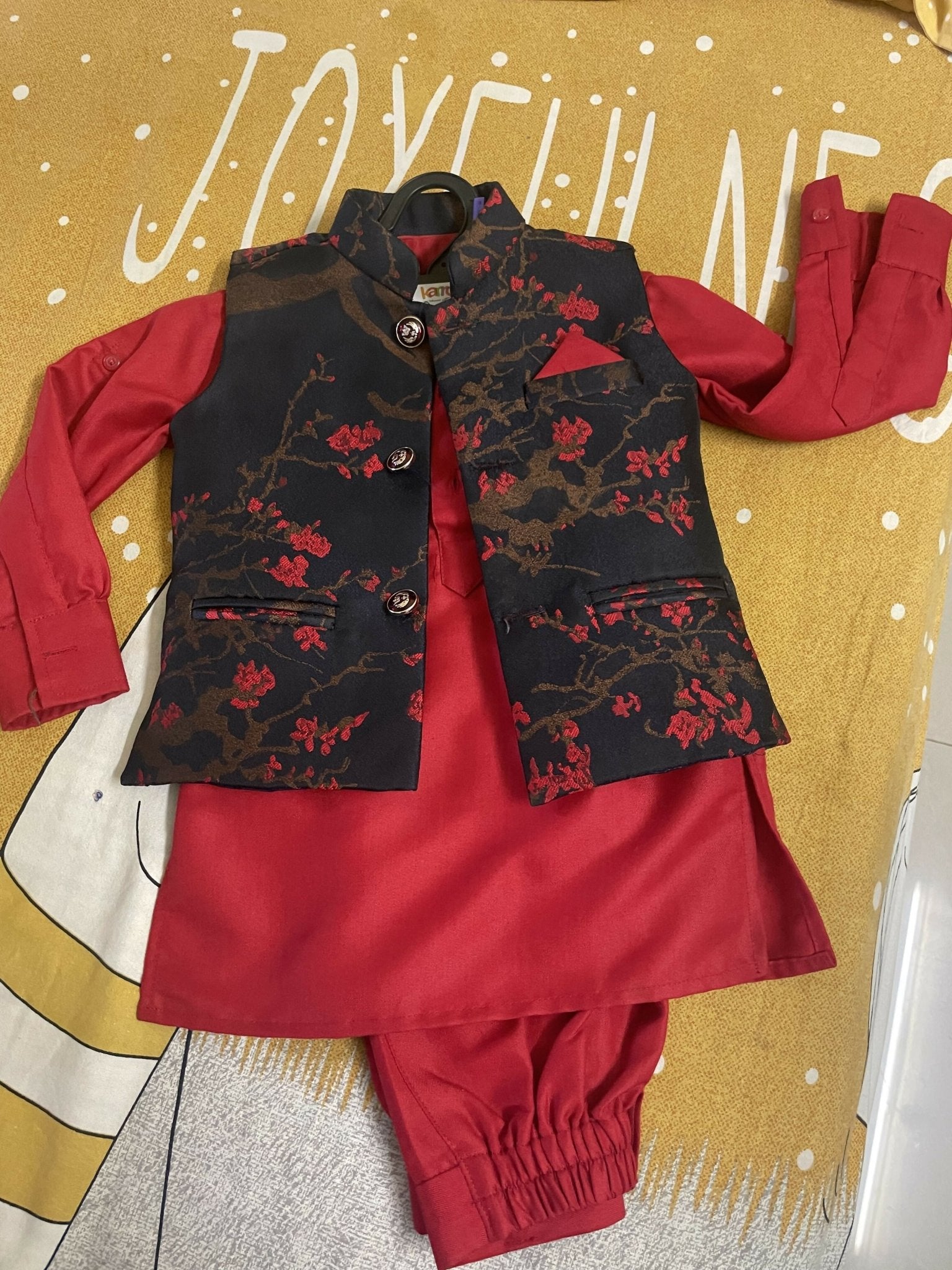 Red outfit with black floral vest