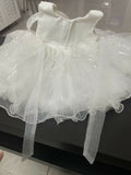 White dress with a sheer overlay on a black surface