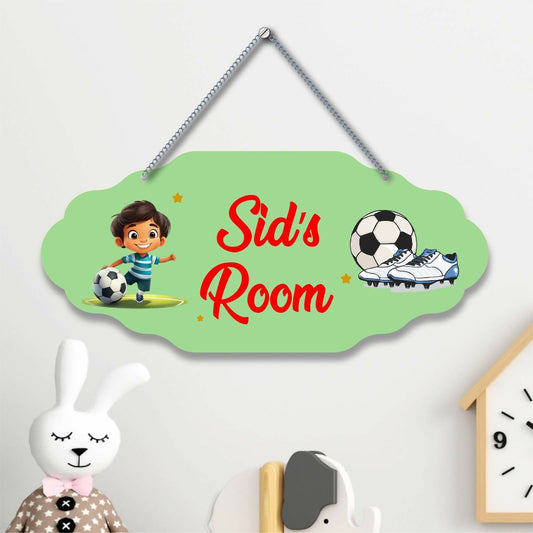 Children's room door sign with cartoon character, soccer ball, and shoes on a light green background.