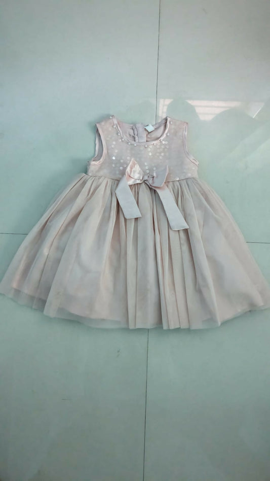 Peach sleeveless dress for baby girls by Babyhug, perfect for summer outings, casual events, and photoshoots.