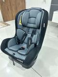 Gray and black car seat on a tiled floor