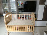 15-in-1 convertible baby cot bed with adjustable mattress heights, sturdy wooden construction, storage space, wheels with locks, mosquito net support, and a multifunctional design that grows with your child.