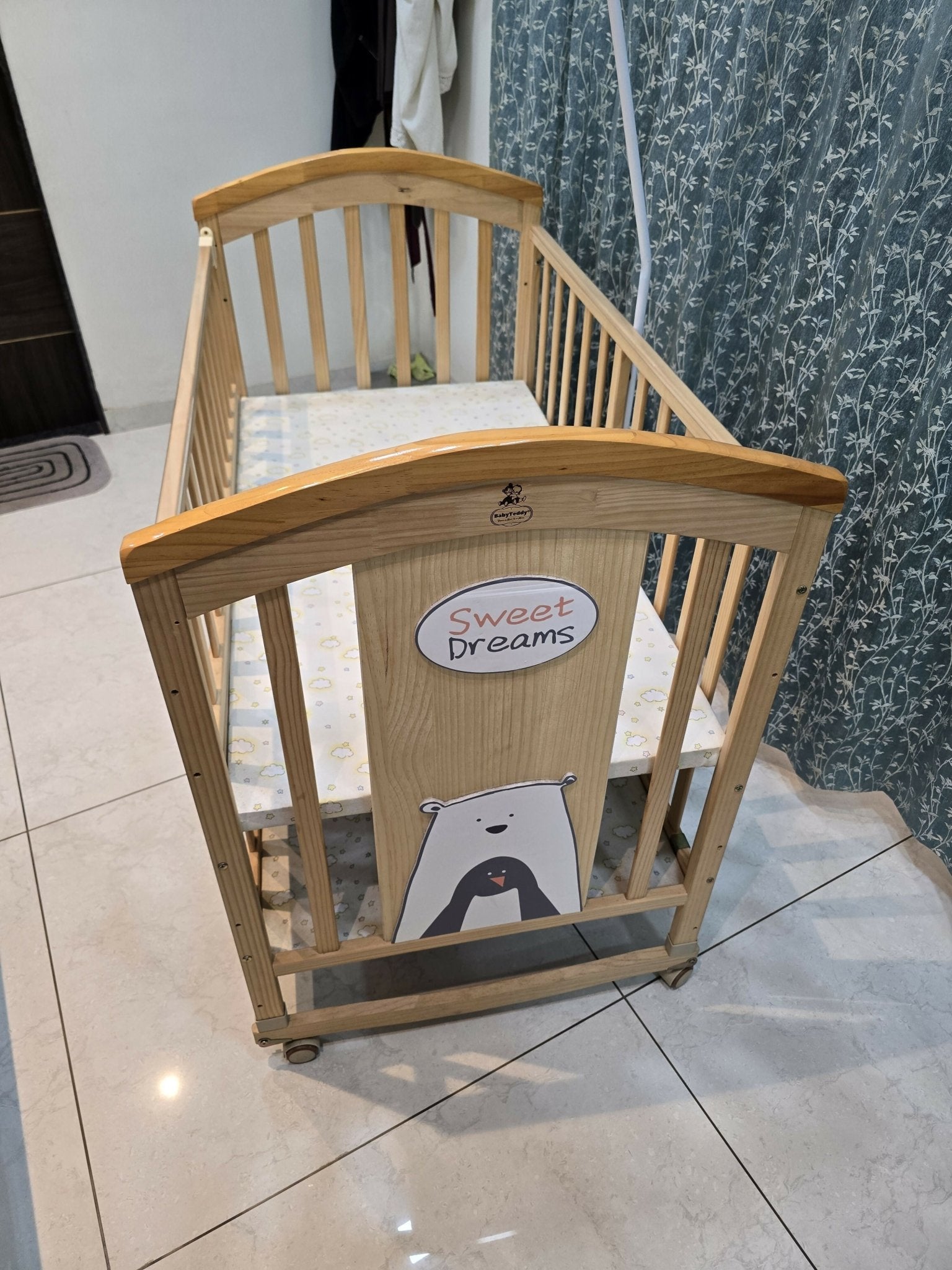 BabyTeddy® 16-in-1 original patented baby crib with convertible cot, toddler bed, cradle rocker, study desk, kids' sofa mode, mosquito net, soft mattress, and diaper changing station for newborns and growing children.