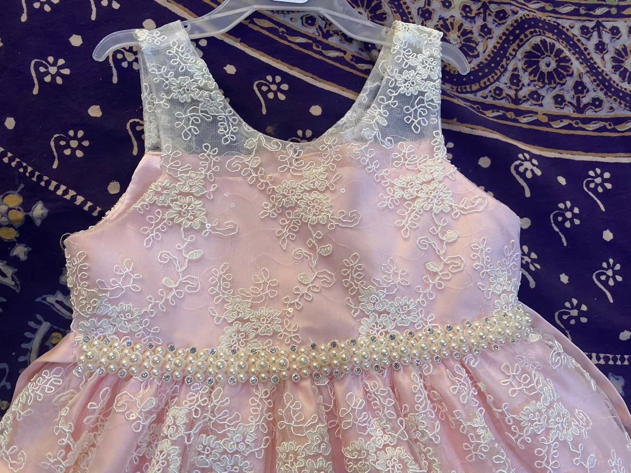 Adorn your baby girl in this elegant Pearl and Lace Work Frock, perfect for making precious memories!






