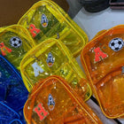 Colorful transparent bags with various designs on a white surface