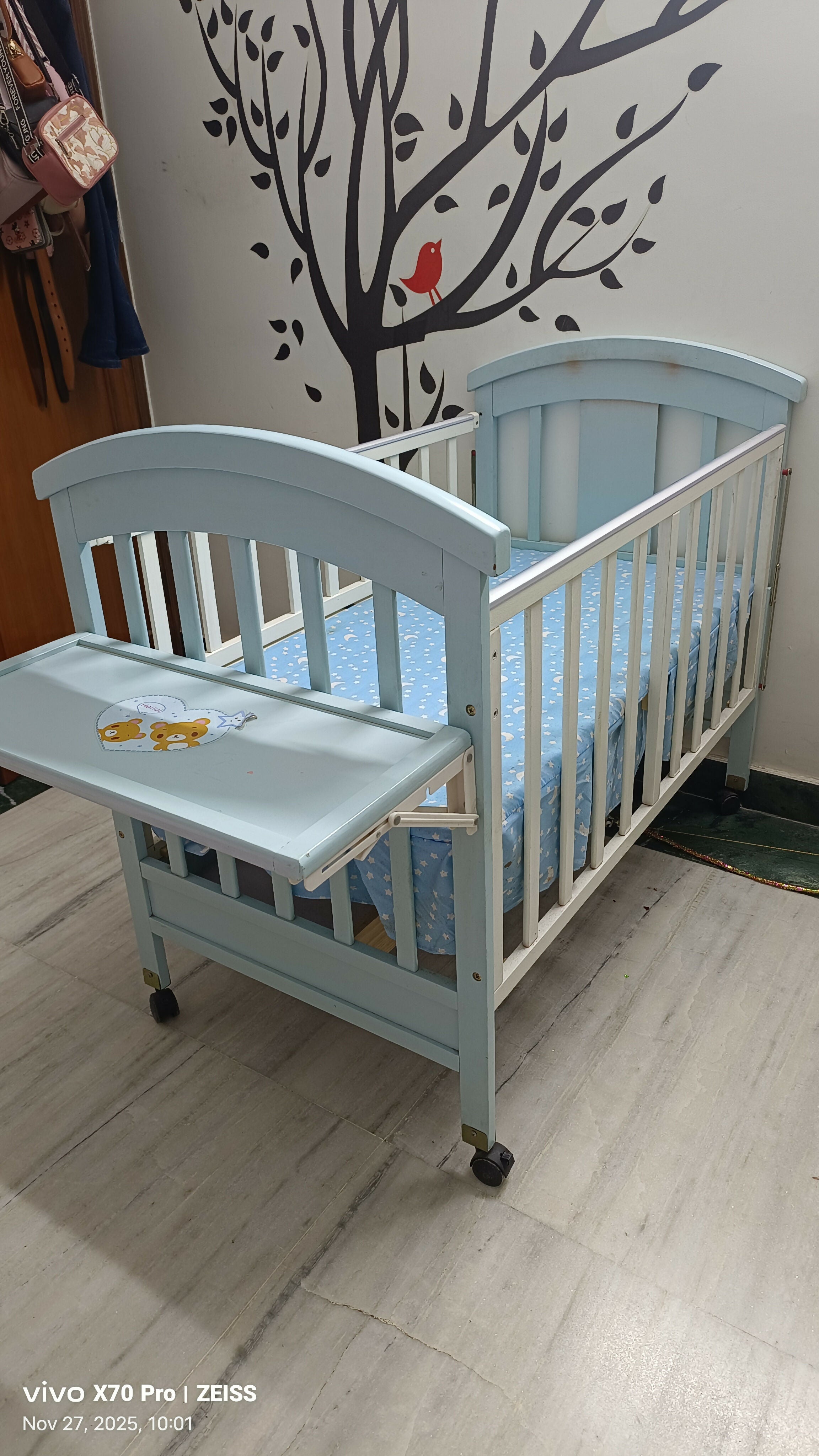 Blue baby cot with mattress and side protector