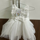 White children's dress with a bow 