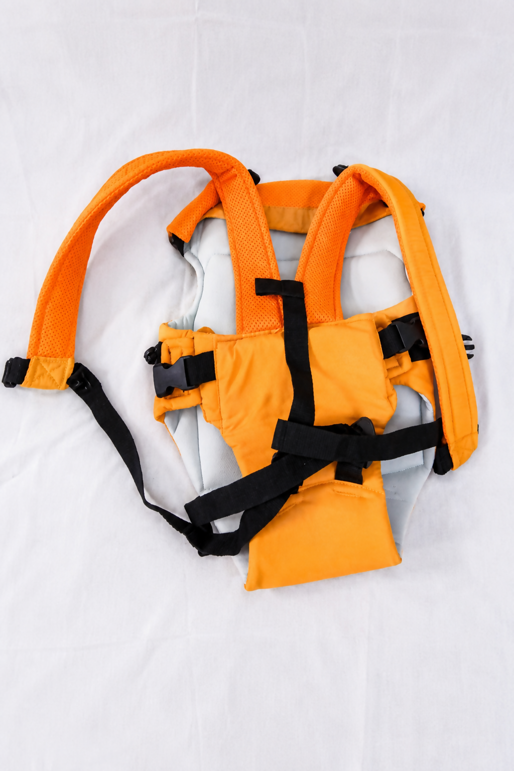 4-in-1 Ergonomic Baby Carrier in Orange with adjustable straps, breathable fabric, padded shoulder support, and multiple carrying positions for comfortable and secure babywearing.