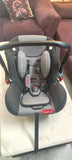 Child car seat on a white surface with a blurred background
