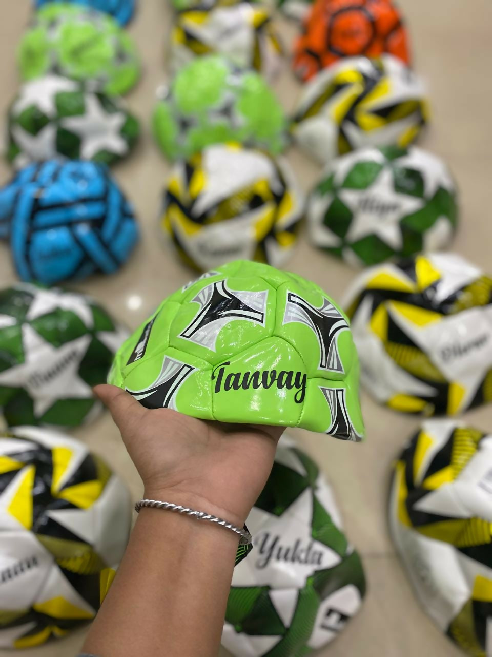 Customized size 5 football with child’s name printed, available in random colors with theme-based personalization options.