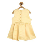 Yellow dress on a wooden hanger against a white background