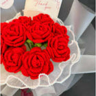 Bouquet of red roses with a 'Thank you' card on a gray surface