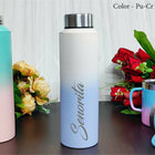 White water bottle with 'Senorita' branding on a wooden surface with flowers and other bottles.