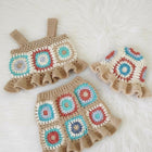 Crocheted baby outfit with colorful square patterns 