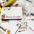 Collection of personalized name cards with cartoon designs on a white surface.