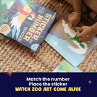 Children's activity book with stickers and a child interacting with the book on a carpeted floor.