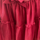 Red dress with a bow detail on a plain background