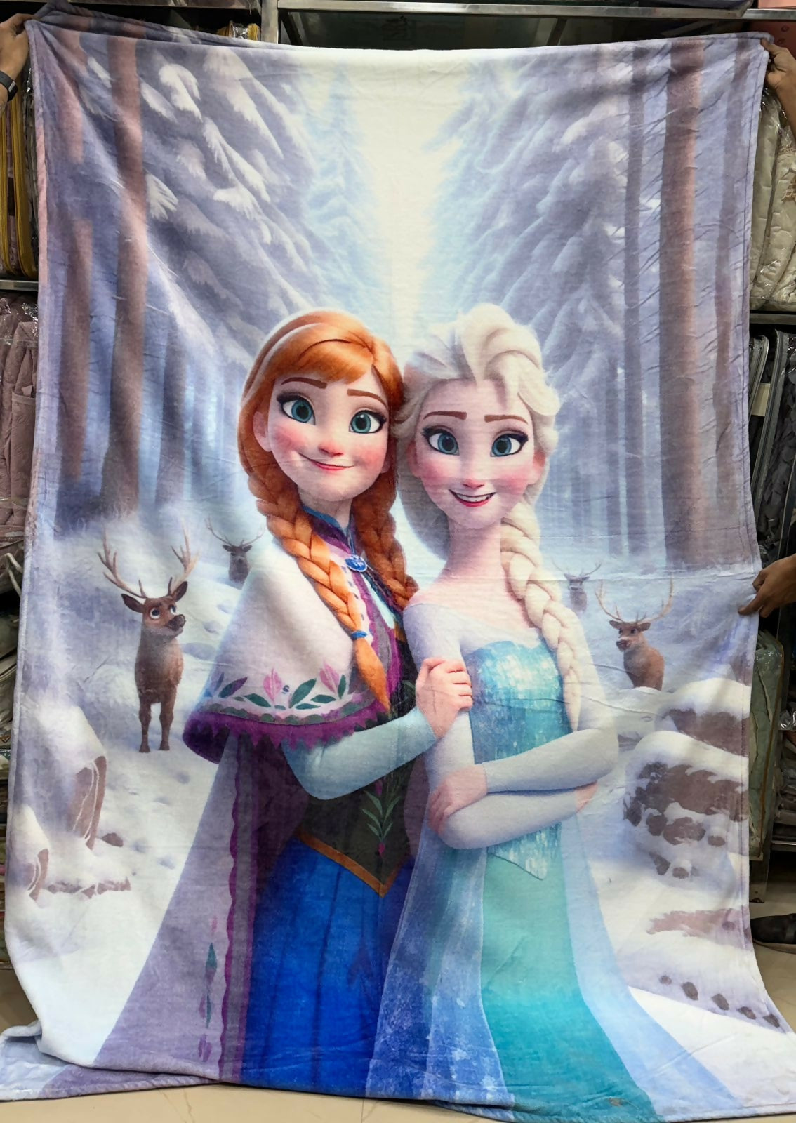 Fleece blanket with characters from 'Frozen' in a snowy forest setting