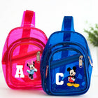 Pink and blue transparent backpacks with cartoon characters on a white background