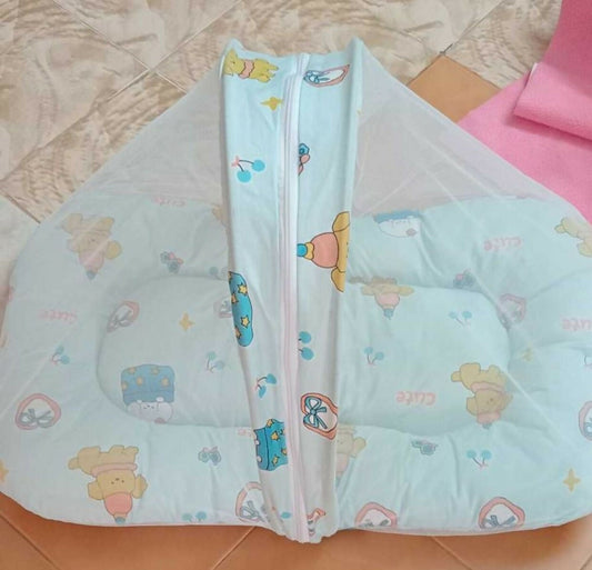Light blue baby pillow with cartoon designs on a tiled floor