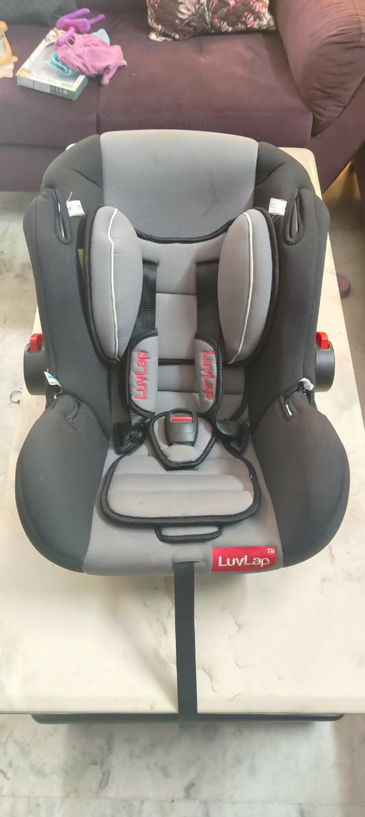 Child car seat on a marble surface with a blurred background