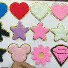 Collection of colorful heart, star, and other shaped patches on a white background.