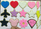 Collection of colorful heart, star, and other shaped patches on a white background.