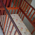 BABYHUG 3 in 1 Wooden Bed Cum Rocker in Some Used condition with bumper set and box foam mattress, featuring a versatile wooden design, rocking function, protective side rails, and comfortable sleeping space for baby.