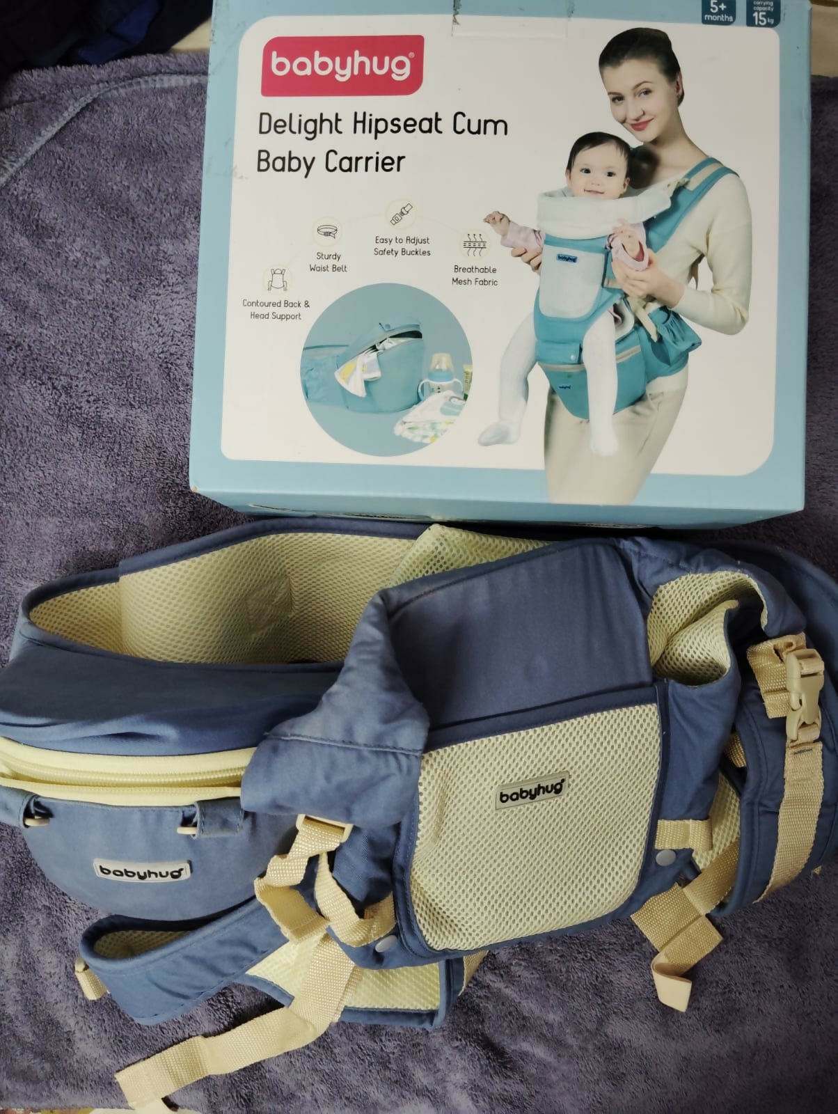 BABYHUG Adore 5-in-1 hip seat baby carrier with ergonomic design, detachable hip seat, multiple carrying positions, padded shoulder straps, adjustable waist belt, and secure buckles for comfortable babywearing.