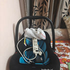 BABYHUG Amber Car Seat Cum Rocker in Almost New condition, featuring comfortable padded seating, safety harness, ergonomic carry handle, protective canopy, and versatile rocking function for convenient infant travel and supervised relaxation.